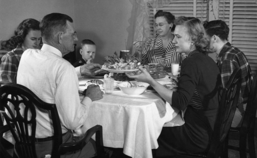 vintage family meal together with both parents grandparents and children present