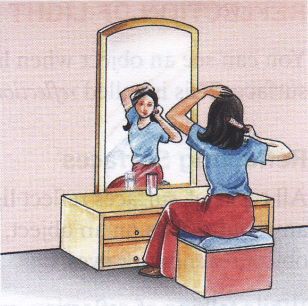 Combing hair at a vanity.