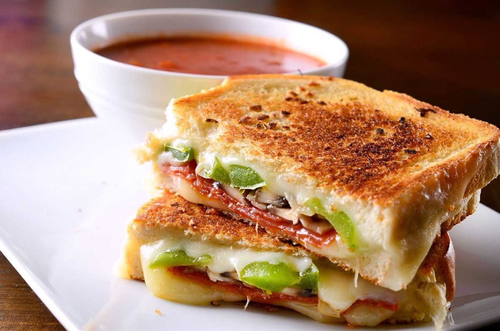 Pepperoni pizza grilled cheese sandwich with homemade tomato soup.