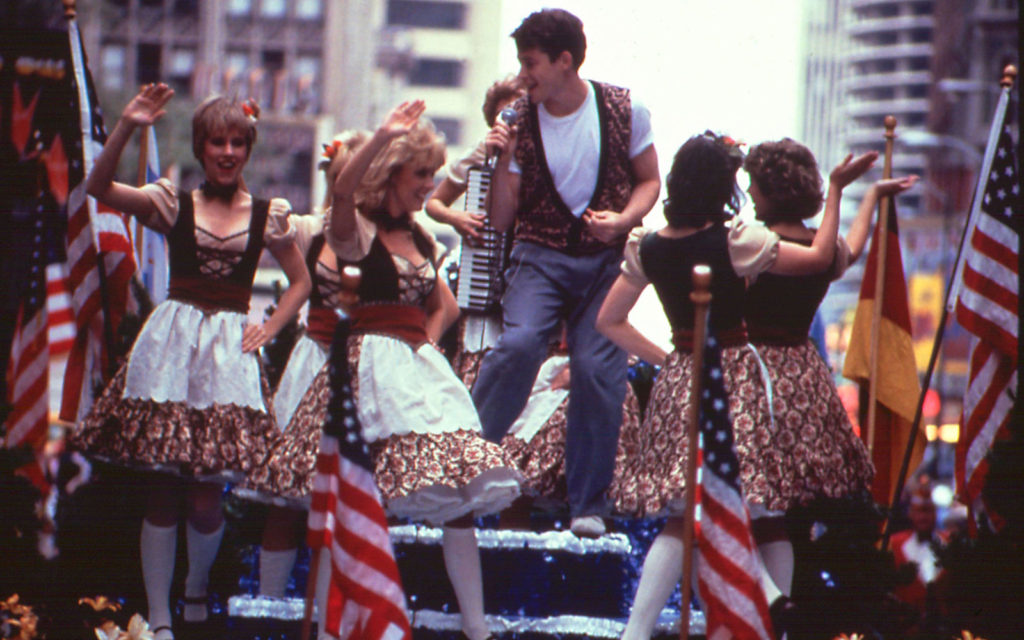 Ferris Bueller having fun during a parade in downtown Chicago.