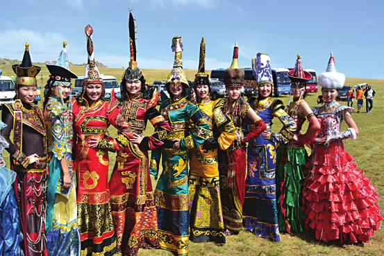 Mongolian women wearing the clothing and hairdresses of their family. Which is, of course, handed down fromgeneration to generation via tradition.