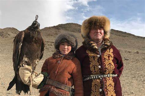 Mongolian father with his fourteen year old daughter going hunting. You see, she hunts using eagles. It's part of their long running conservative culture.
