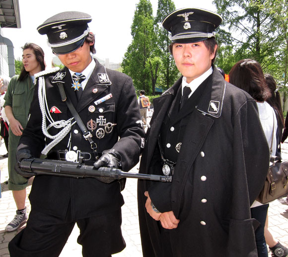 Asian Nazi fashion. It's not uncommon to see young people dressing like this and goose-stepping down the streets. No one bats an eye. Though, seeing a "white water buffallo" (American woman) would most certainly invole stares and snickers of polite laughter and disgust.