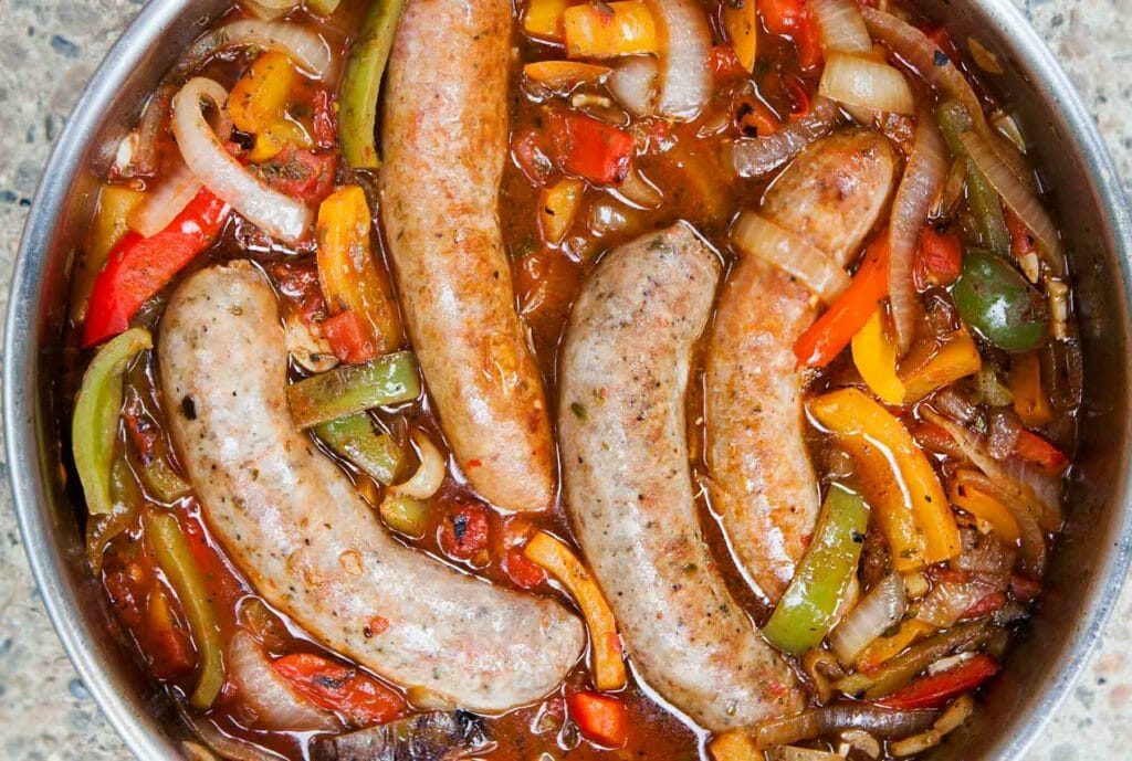 --PHOTO--Such a satisfying combo! Italian sausages cooked with bell peppers, sweet onions, crushed tomatoes, and garlic. Served on a hoagie roll or over pasta or polenta.