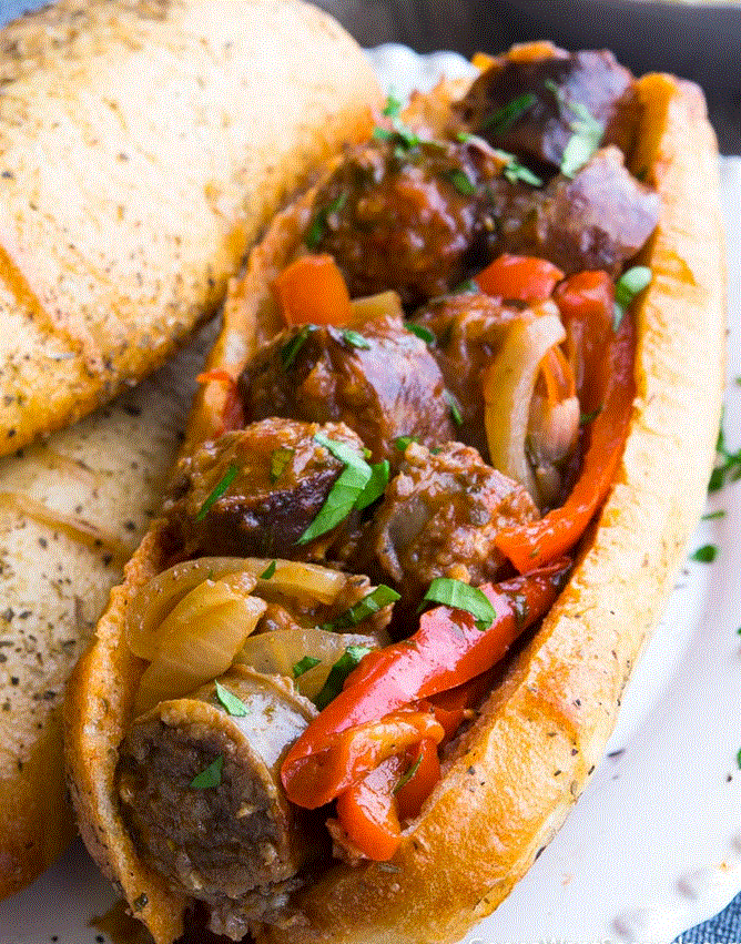 --PHOTO--Here is a most delicious Italian sausage meal. The sausage is slow cooked in a crock pot for four hours or so with Italian spaghetti sauce, some peppers and onions, and then removed and placed on a freshly baked hard roll. It i a most excellent family lunch, but makes a wonder dinner when paired with a bowl of creamy soup. Yum!