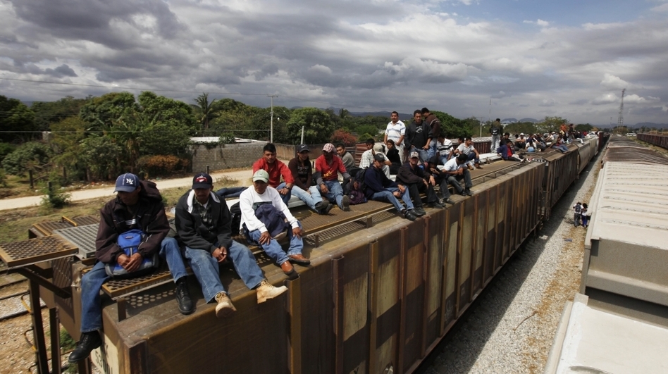 Migrants ride on top of a northern bound train toward the U.S.-Mexico border in Oaxaca, southern Mexico, in March. Migrants crossing Mexico to get to the U.S. have increasingly become targets of criminal gangs who kidnap them to obtain ransom money.