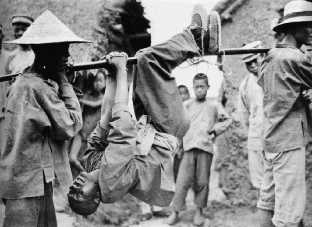 Nationalist prisoner captured by the Marxists and paraded before the townspeople before being tortured and killed.