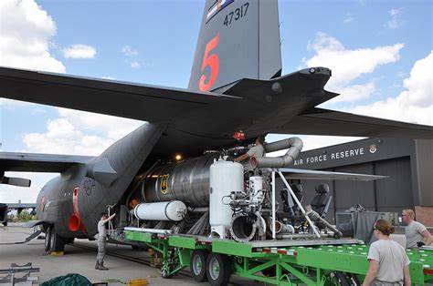 A spraying and aerosol mixing assembly system being installed and loaded into a C-130 cargo plane for undisclosed purposes.