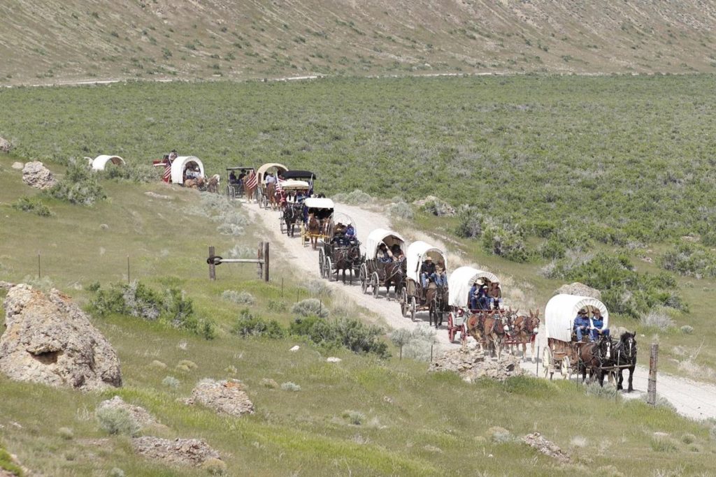 Wagon train in the Americas. During this period of time, European settlers formed these convoys of wagons and people moved West to find lands to settle upon. It is unfortunate that they lands were already occupied and the Indians that occupied them did not want these strangers taking their lands.
