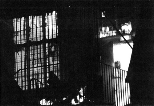 On November 19, 1995, Wem Town Hall in Shropshire, England burned to the ground. Many spectators gathered to watch the old building, built in 1905, as it was being consumed by the flames. Tony O'Rahilly, a local resident, was one of those onlookers and took photos of the spectacle with a 200mm telephoto lens from across the street. One of those photos shows what looks like a small, partially transparent girl standing in the doorway. Nether O'Rahilly nor any of the other onlookers or firefighters recalled seeing the girl there. 