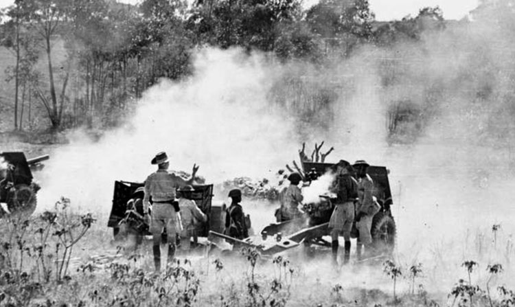 British colonial troops fire their field artillery pieces toward Vichy French entrenchments on Madagascar. Defending their government’s sovereign territory, the Vichy soldiers were defeated after several sharp fights with the British forces. This action took place near the village of Ambositra.