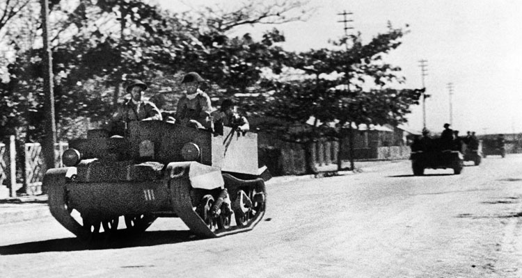 A British Bren gun carrier rolls down a street in the town of Majunga on Madagascar. By the time this photo was taken on October 5, 1942, the British were gaining control of the island. A month later the Vichy surrender went into effect.