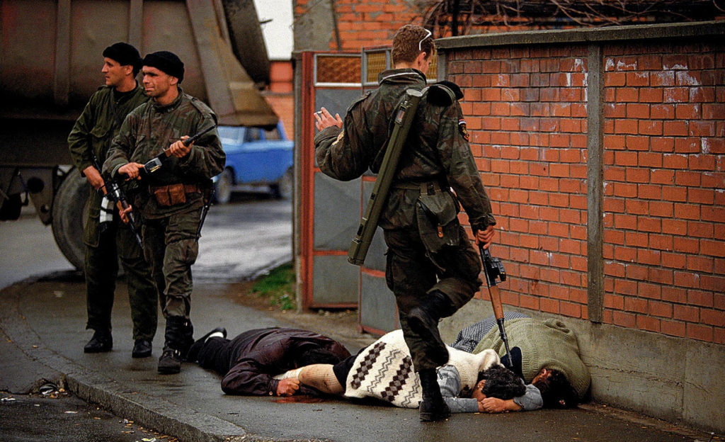 Arkan's Tigers kill Bosnian Muslim civilians during the first battle for Bosnia in Bijeljina, Bosnia, March 31, 1992. The Serbian paramilitary unit was responsible for killing thousands of people during the Bosnian war, and Arkan was later indicted for war crimes. This image and the series that accompanies it were used for evidence in the International War Crimes Tribunal for the indictment and conviction of Serbian leaders.